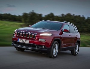 dark red SUV on country road