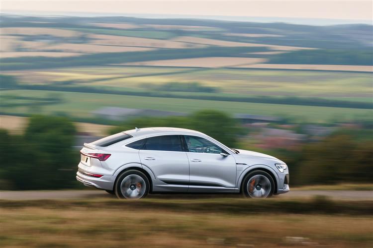The current Audi E-Tron Sportback driving through the countryside