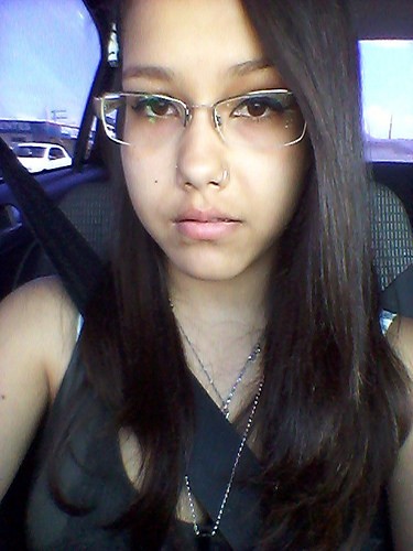 Is this a driving Selfie ? Girl with long hair and glasses driving
