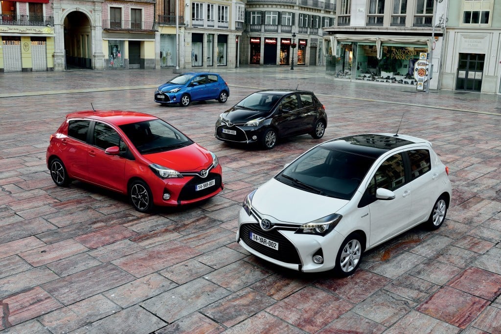 4 different coloured hatchbacks in a paved square