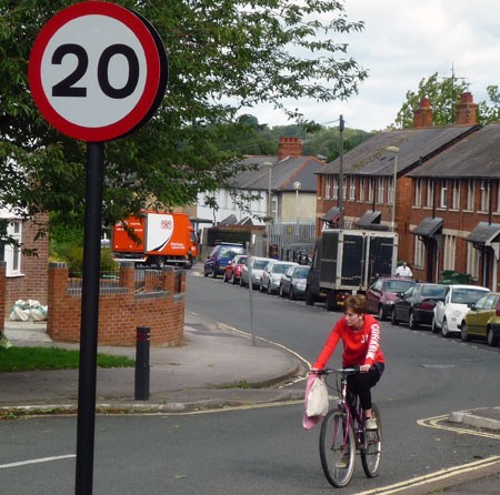 Most motorists don’t want 20mph zones 20 miles per hour road sign with cyclist in small town road