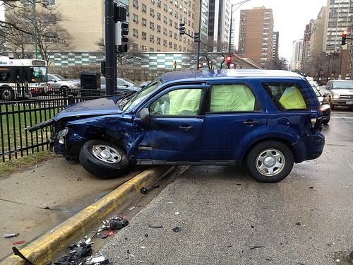 Accident - Blue SUV with destroyed front end against black railings