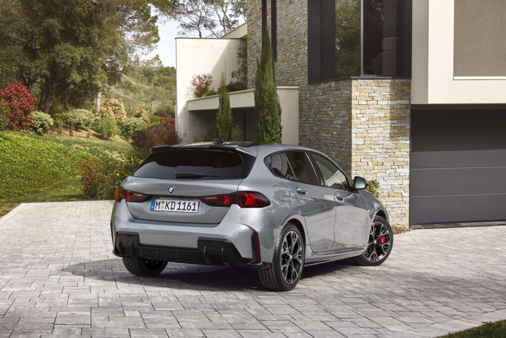 BMW 2025 1 Series review- Rear shot of new BMW 1 Series in front of smart, on trend German home