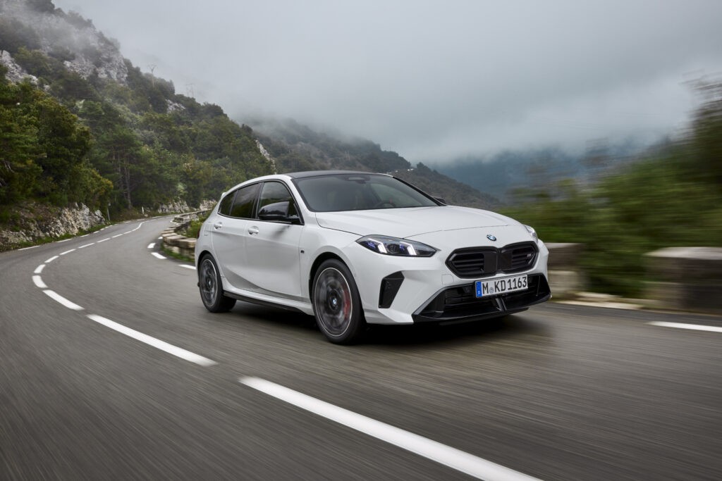 BMW 2025 1 Series review- White BMW 1 series front view on mountainous road 