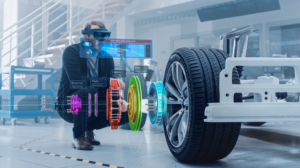 Regenerative Braking Technician analysing EV braking system in modern hi tech workshop